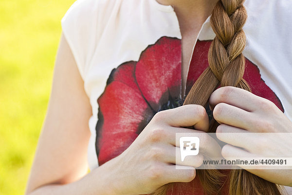 Woman braiding hair  mid section