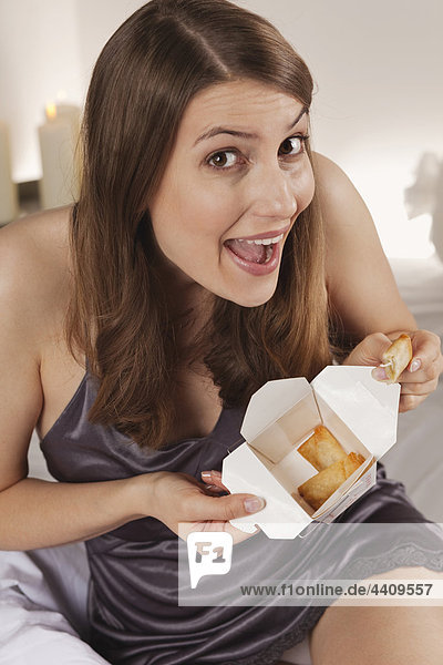 Woman holding box with asian food  portrait