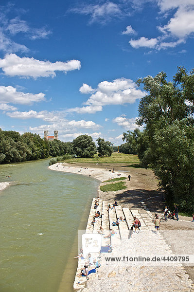 Germany  Bavaria  Munich  People at river isar with st. maximilian church in background