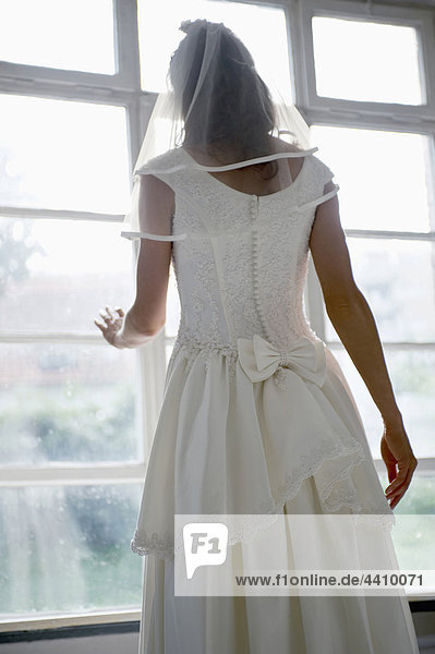 Braut schaut durchs Fenster  Rückansicht