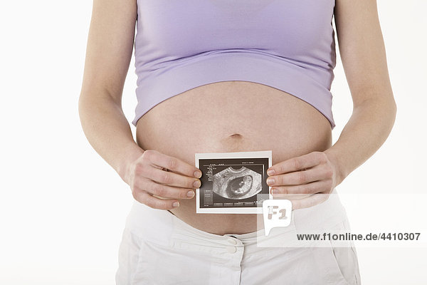 Schwangere Frau mit Sonogrammaufnahme  Mittelteil