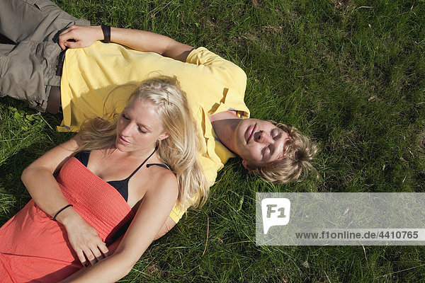 Germany  Dortmund  Young couple resting on grass