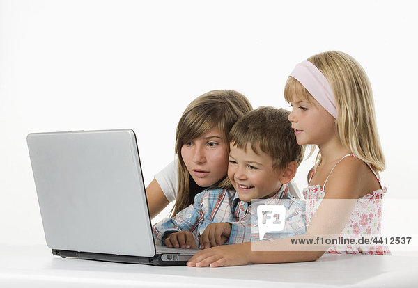 Children (2-11) using laptop  smiling