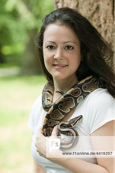Woman with a snake around her neck