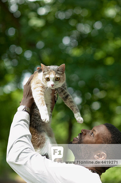 Man lifting a cat up