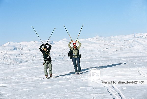 Tourists carrying ski poles