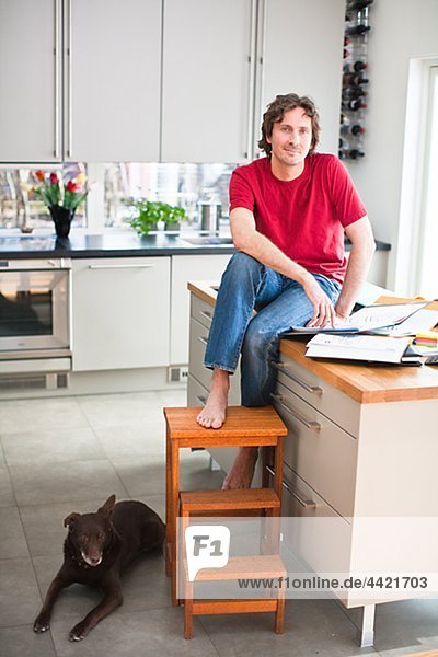Mid adult man with dog  working from home