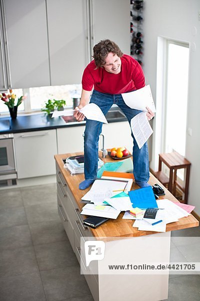 Man struggling with domestic paperwork