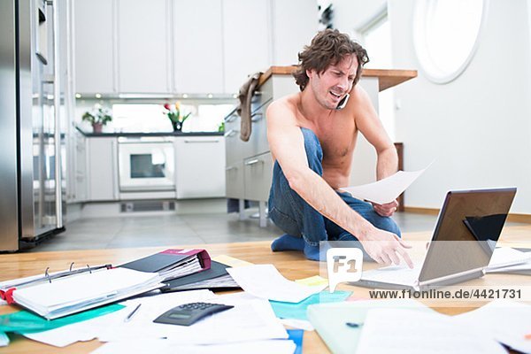 Frustrated man struggling with domestic paperwork