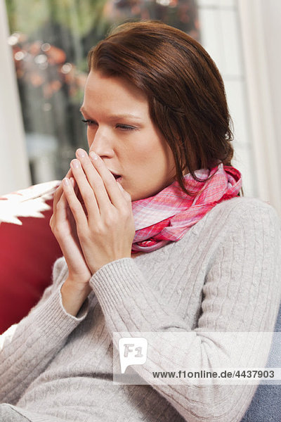 Young woman coughing
