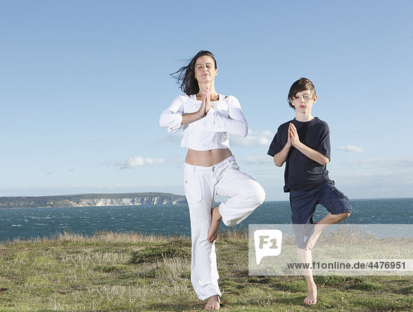 Mother and son practicing yoga