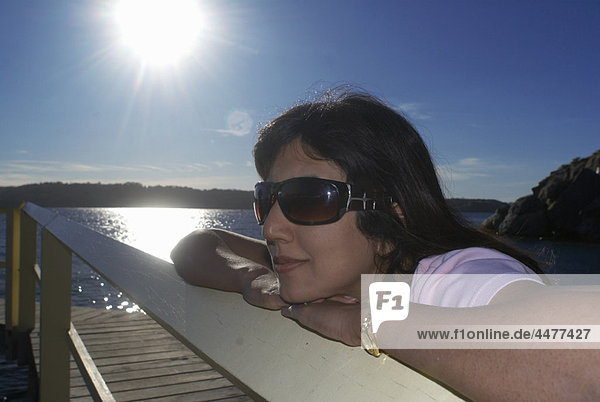 Woman relaxing by boat house