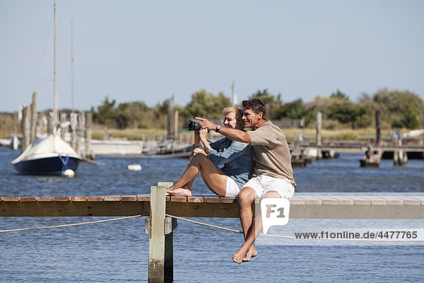Couple sitting on a dock