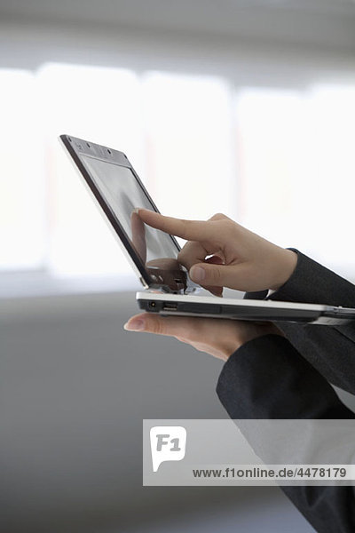 Woman's hand holding tablet computer