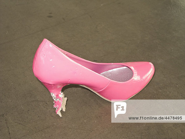 A pink stiletto with bit marks