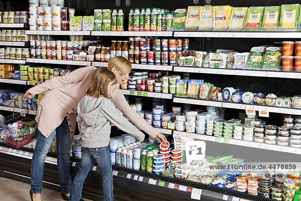A mother and daughter shopping at the supermarket