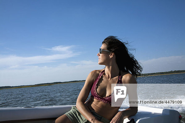 A woman relaxing in a motorboat