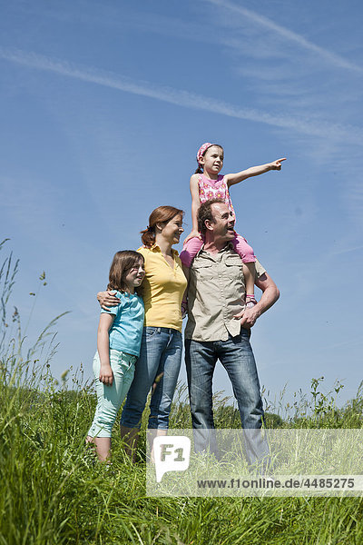 Family standing on a meadow