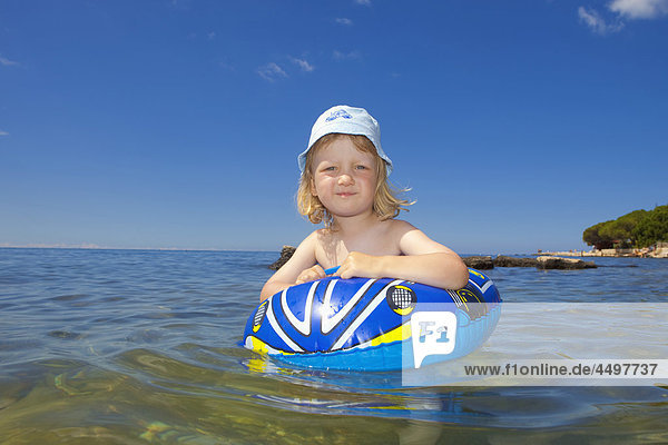 Adriatic  boy  child  coast  coastline  Croatia  day  hat  Europe  inflatable  istra  Istria  Mediterranean  ring  sea  summer  sun  travel  vacations  water