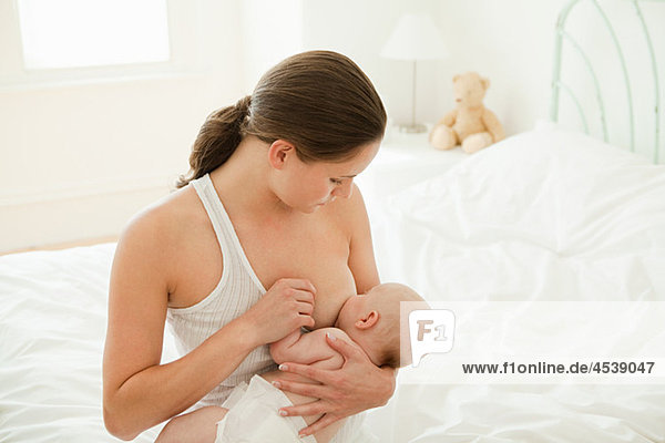 Mother breast feeding baby son