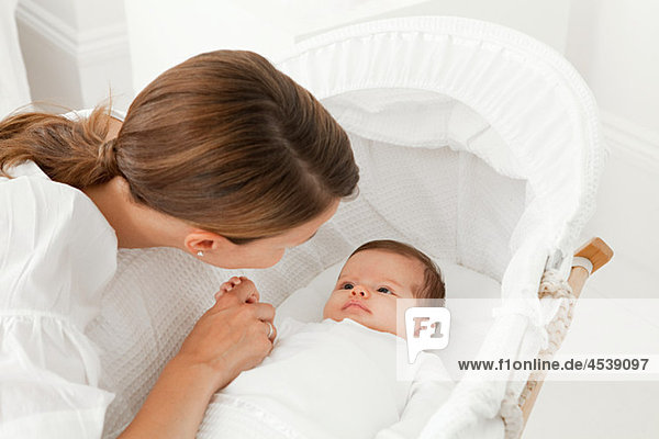 Mother with baby in bassinet