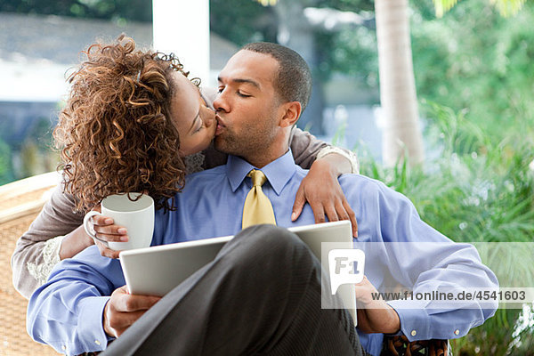 Kissing couple with laptop