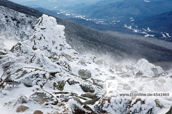 Strong winds blow snow across the open ridge of Mount Lafayette along the Greenleaf Trail during the winter months in the White Mountains  New Hampshire USA