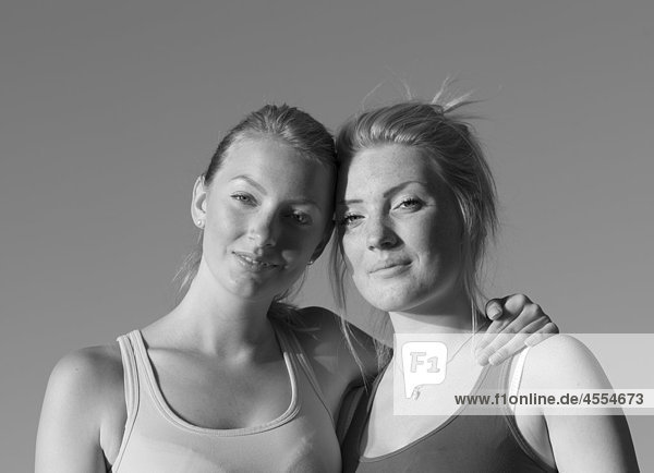 Two women standing with arm around  portrait