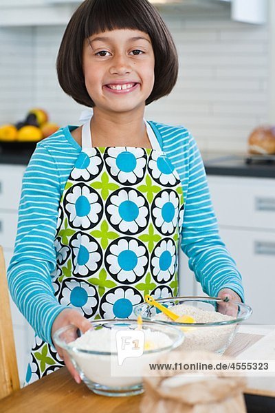 Porträt von Mädchen hält Zutaten in Küche