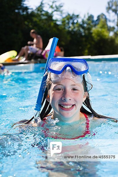 Portrait of girl with scuba mask in swimming pool