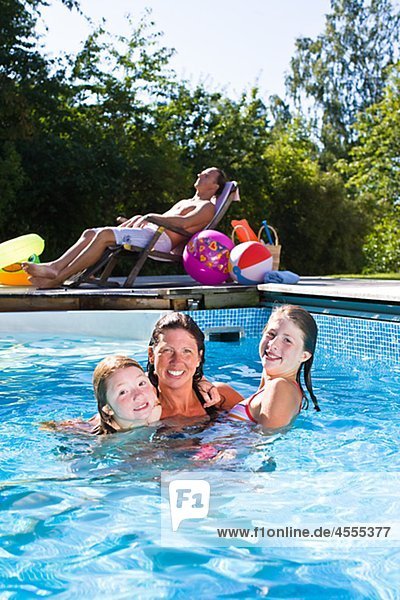 Portrait of mother with children in swimming pool
