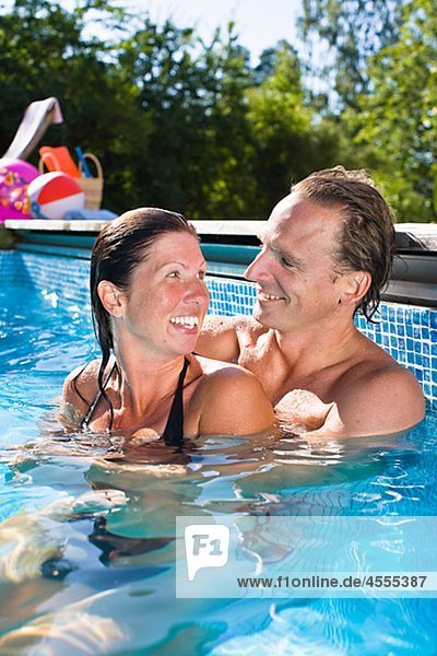 Portrait of couple in swimming pool