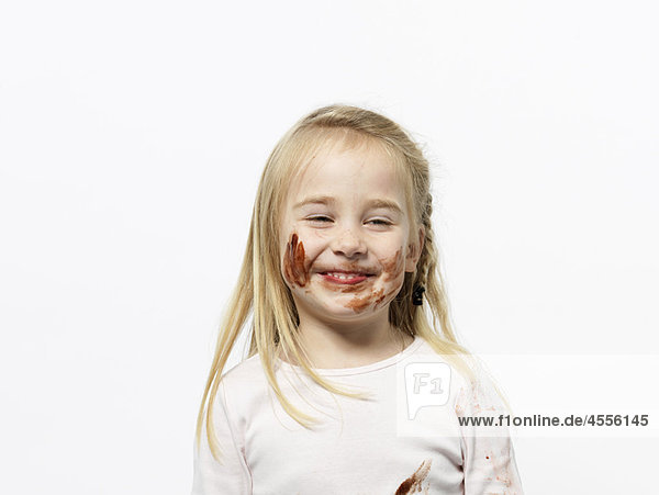 Girl playing with chocolate sauce