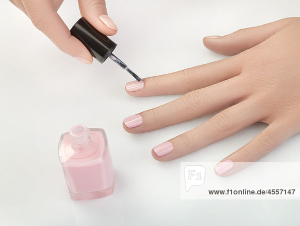 Woman painting fingernails  close-up