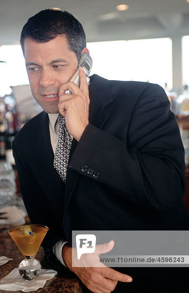 man in a suit on a cell phone