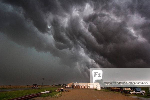 Roiling outflow clouds behind a supercellular thunderstorm producing a tornado near Quinter  Kansas  May 23  2008