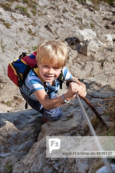 Boy (4-5 Years) climbing mountain  smiling  portrait
