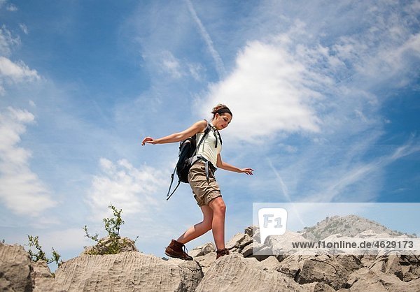 Croatia  Zadar  Young woman balancing over rocks