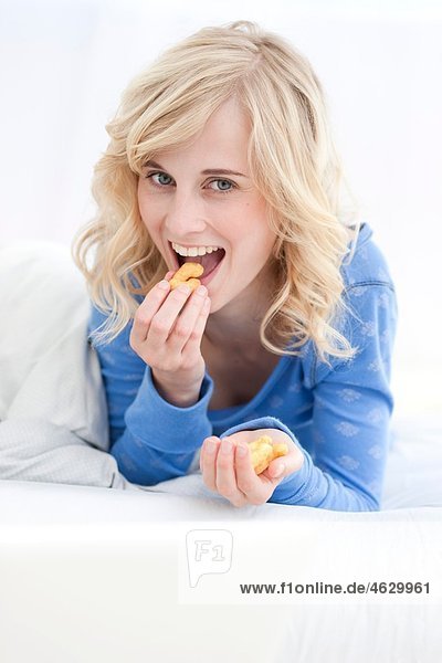 Young woman eating and smiling  portrait