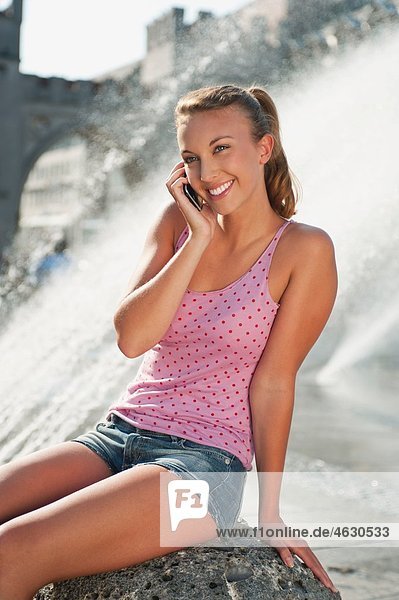 Young woman on the phone  smiling