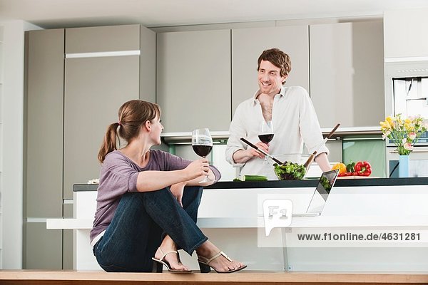 Man and woman in kitchen  smiling
