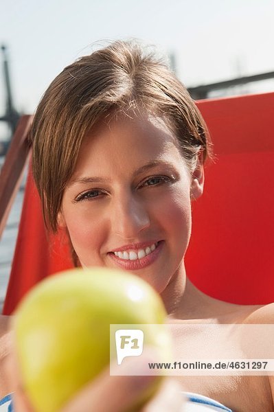 Woman with apple  smiling  portrait