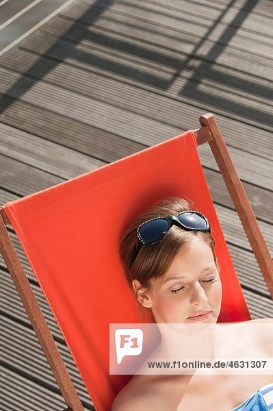Woman resting on deck chair