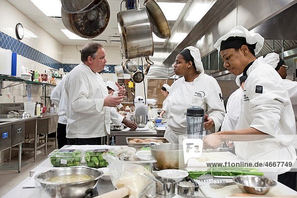 Roseville  Michigan - Instructor John Adamski works with students preparing food at the Dorsey Culinary Academy  a private career training school