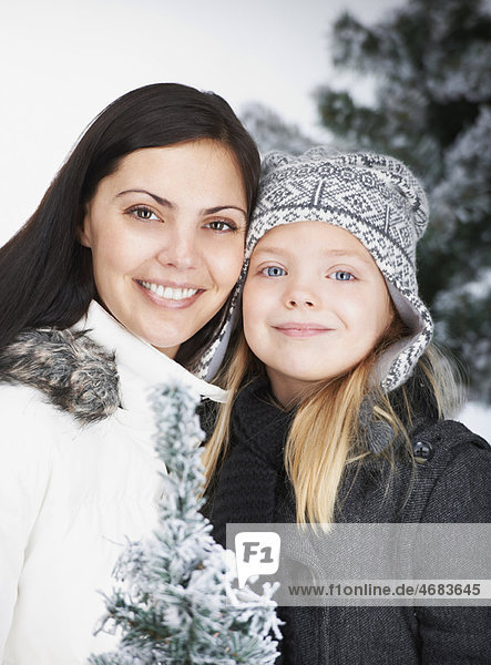 Mother and daughter  outdoor by winter