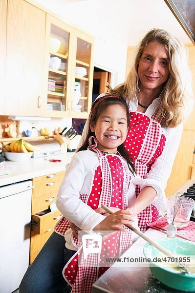Portrait of mother and child cooking together