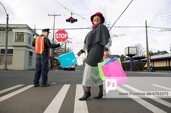 Woman with shopping bags crossing street