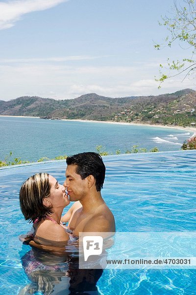 Vacationing couple in swimming pool