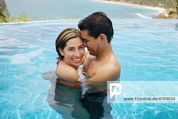 Vacationing couple in swimming pool