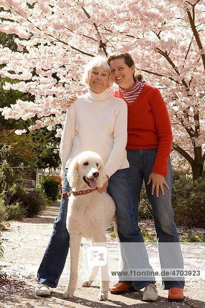 Portrait of mother with grown daughter and dog